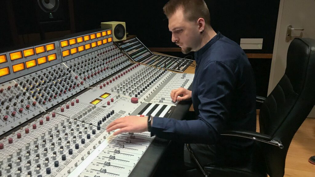 An engineer mixing on the analogue console