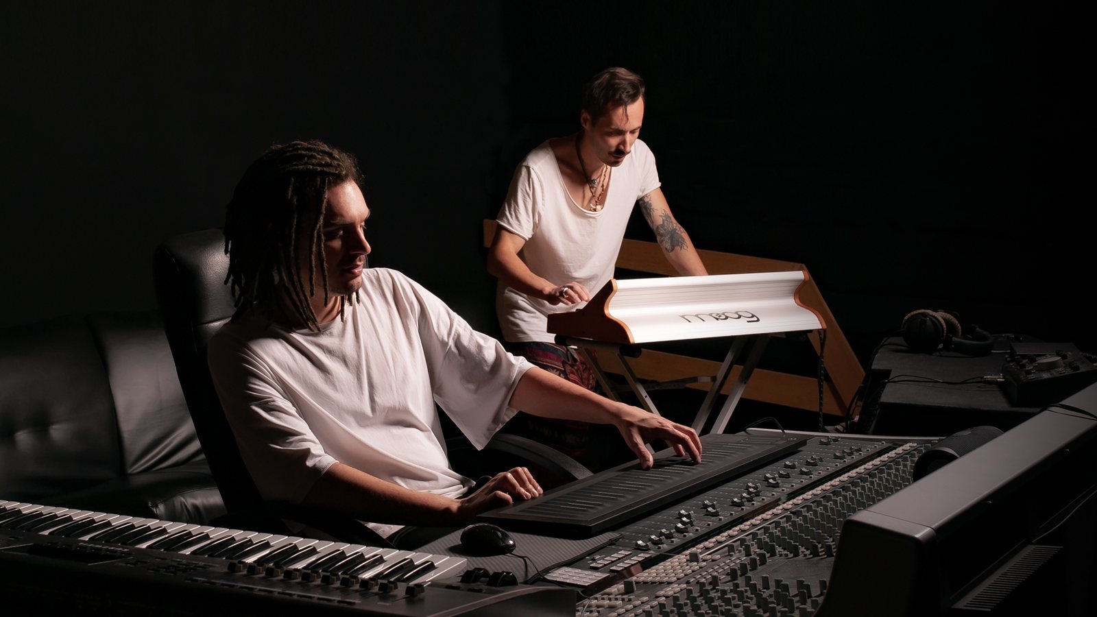 Two producers working on a track together in the studio