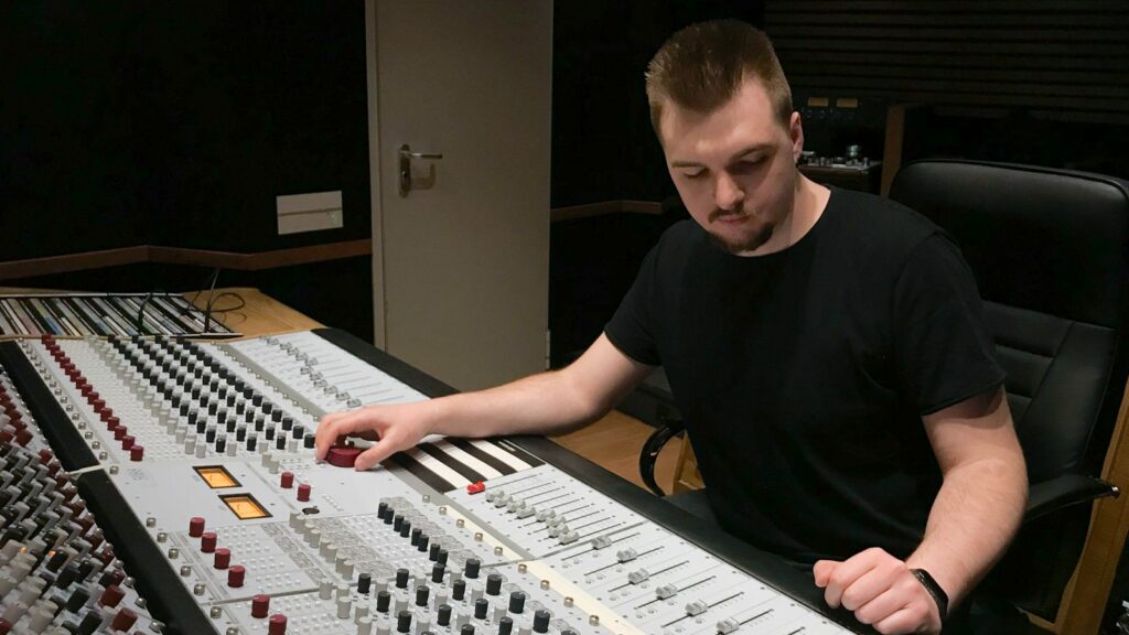 A mastering engineer listening through a mix